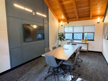 A conference room with a long table and chairs at The Lakes in Bellevue, 98007
